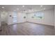 Bright living room featuring recessed lighting, light gray floors, and several windows at 163 Dolphin E Dr, Oldsmar, FL 34677