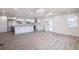 Open-concept living space with modern flooring, white walls, and abundant natural light at 163 Dolphin E Dr, Oldsmar, FL 34677