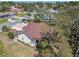 Lovely aerial view of a home surrounded by mature trees, gardens, and landscaping in a residential neighborhood at 18739 Bascomb Ln, Hudson, FL 34667