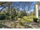 Large backyard with mature trees offering shade and privacy, creating a serene outdoor space at 18739 Bascomb Ln, Hudson, FL 34667