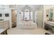 Well-lit bathroom featuring a garden tub, shower, and dual vanities at 18739 Bascomb Ln, Hudson, FL 34667