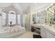 Bright bathroom with a garden tub, shower, and dual vanities at 18739 Bascomb Ln, Hudson, FL 34667