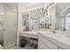 Elegant bathroom vanity with mirrors, great lighting, and a shower at 18739 Bascomb Ln, Hudson, FL 34667