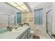 Bathroom featuring tile, a large mirror, and a glass-door shower at 18739 Bascomb Ln, Hudson, FL 34667