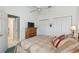 Bedroom featuring a double closet, ceiling fan, and view to the en-suite bathroom at 18739 Bascomb Ln, Hudson, FL 34667