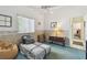 Cozy bedroom with a daybed, vintage furniture, and natural light, creating a relaxing and inviting space at 18739 Bascomb Ln, Hudson, FL 34667