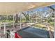 Bocce ball court with covered seating area, providing a shaded space for outdoor recreation at 18739 Bascomb Ln, Hudson, FL 34667