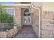 Inviting walkway leading to the front door with brick accents and a well-maintained garden at 18739 Bascomb Ln, Hudson, FL 34667