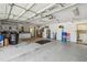 Functional garage with a clean floor, workbench, and organized storage, perfect for projects and organization at 18739 Bascomb Ln, Hudson, FL 34667