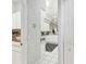Hallway view leading into the kitchen, showing the laundry area on the left at 18739 Bascomb Ln, Hudson, FL 34667