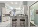 Bright kitchen with white cabinetry, bar seating, and tile floors at 18739 Bascomb Ln, Hudson, FL 34667