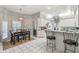 Bright kitchen features white cabinets, tile floors, and a cozy dining area with a hanging light fixture at 18739 Bascomb Ln, Hudson, FL 34667