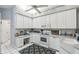 Bright kitchen features white cabinetry, modern appliances, and a stylish blue accent rug at 18739 Bascomb Ln, Hudson, FL 34667