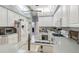 Well-lit kitchen with white cabinets, modern appliances, and a convenient workspace area at 18739 Bascomb Ln, Hudson, FL 34667