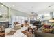 Inviting living room featuring a fireplace, comfortable seating, and an open view to the kitchen at 18739 Bascomb Ln, Hudson, FL 34667
