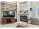 Comfortable living room featuring a fireplace, built-in shelves, and entertainment center at 18739 Bascomb Ln, Hudson, FL 34667