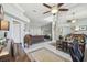 Open concept living room with tile floors, ceiling fan, and view into sitting room, offering ample space at 18739 Bascomb Ln, Hudson, FL 34667