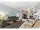 Cozy living room with a ceiling fan, fireplace, and comfortable seating arrangements at 18739 Bascomb Ln, Hudson, FL 34667