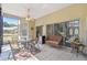 Inviting screened patio with comfortable seating, ceiling fan, and tile flooring, ideal for outdoor dining and relaxation at 18739 Bascomb Ln, Hudson, FL 34667