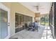 Charming screened patio with tile floors, ceiling fan, and comfortable seating, creating a serene outdoor retreat at 18739 Bascomb Ln, Hudson, FL 34667