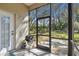 Cozy screened porch featuring a grill, ideal for outdoor cooking and entertaining at 18739 Bascomb Ln, Hudson, FL 34667