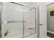 Shower stall with glass sliding door, along with a view to the nearby doorway at 18739 Bascomb Ln, Hudson, FL 34667