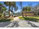 View of the tennis courts, landscaping, and a small building in a well-maintained recreational area at 18739 Bascomb Ln, Hudson, FL 34667