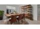 Elegant dining room with a rustic wooden table, leather chairs, and stylish shelving at 20723 Balsam Hill Rd, Land O Lakes, FL 34638