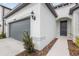 A well-maintained front exterior features a gray garage door, and manicured landscaping at 20723 Balsam Hill Rd, Land O Lakes, FL 34638