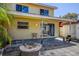 View of backyard patio, sliding door, and exterior wall on a sunny day at 2073 Madrid N Ct, Clearwater, FL 33763