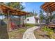 Backyard with a pergola, patio, and charming stucco house at 2227 29Th S St, St Petersburg, FL 33712
