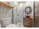 Updated bathroom features patterned tile, modern fixtures, and glass enclosed shower at 2227 29Th S St, St Petersburg, FL 33712