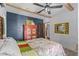 Cozy bedroom featuring wood beam ceiling and a red armoire at 2227 29Th S St, St Petersburg, FL 33712