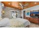 Bedroom with wood plank ceiling, stone accent wall, and backyard access at 2227 29Th S St, St Petersburg, FL 33712