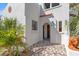 Elegant home entrance with a stucco exterior, arched doorway, and brick-paved walkway at 2227 29Th S St, St Petersburg, FL 33712