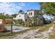 Beautiful two-story home featuring a red tile roof, white stucco exterior, and mature landscaping at 2227 29Th S St, St Petersburg, FL 33712