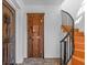 Inviting home foyer showcasing a solid wood door and staircase with iron railing at 2227 29Th S St, St Petersburg, FL 33712