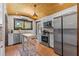 Updated kitchen with stainless steel appliances, terracotta tile floors, and wooden island at 2227 29Th S St, St Petersburg, FL 33712