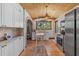 Charming kitchen with stainless steel appliances, terracotta tile floors, and wood plank ceiling at 2227 29Th S St, St Petersburg, FL 33712