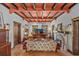 Bright living room featuring exposed beams, terracotta tile floors, and a decorative fireplace at 2227 29Th S St, St Petersburg, FL 33712