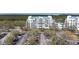 Aerial view of condominiums featuring ample parking and beautiful landscaping at 2333 Feather Sound Dr # A308, Clearwater, FL 33762