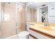 Bathroom featuring a glass shower, toilet, and vanity sink with ample lighting at 2333 Feather Sound Dr # A308, Clearwater, FL 33762