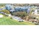 Beautiful condo complex featuring lush green lawns, a serene lake, and a golf course at 2333 Feather Sound Dr # A308, Clearwater, FL 33762