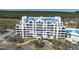 Stunning multi-story condo with blue accents, lush landscaping, and circular driveway at 2333 Feather Sound Dr # A308, Clearwater, FL 33762