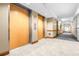Hallway with elevators, neutral walls, and carpet leading to residences at 2333 Feather Sound Dr # A308, Clearwater, FL 33762