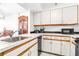 Functional kitchen featuring white cabinets, modern appliances, and durable countertops at 2333 Feather Sound Dr # A308, Clearwater, FL 33762