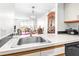 Bright kitchen featuring stainless steel sink and modern appliances, flowing into the dining area at 2333 Feather Sound Dr # A308, Clearwater, FL 33762