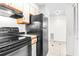Galley kitchen with black appliances, tile floors, and wooden cabinets at 2333 Feather Sound Dr # A308, Clearwater, FL 33762