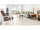 Bright living room featuring a balcony, comfortable seating, and natural light at 2333 Feather Sound Dr # A308, Clearwater, FL 33762