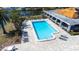 Aerial view of a large rectangular pool surrounded by lounge chairs and a shaded area at 2333 Feather Sound Dr # A308, Clearwater, FL 33762